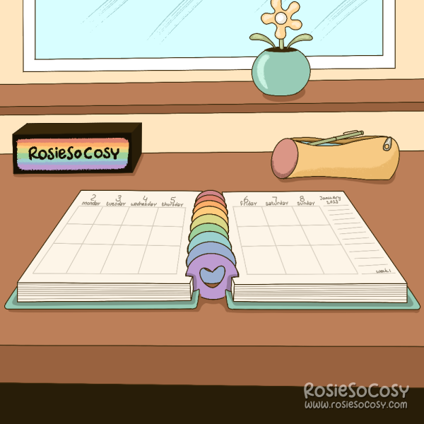 An illustration of a planner on a desk. The planner has a vertical layout with room for notes on the right page. In the background on the left is a rainbow RosieSoCosy logo, matching the discs used in the planner. On the right there’s a yellow and pink pencil pouch. Above it is a window and window sill with a solar flower.