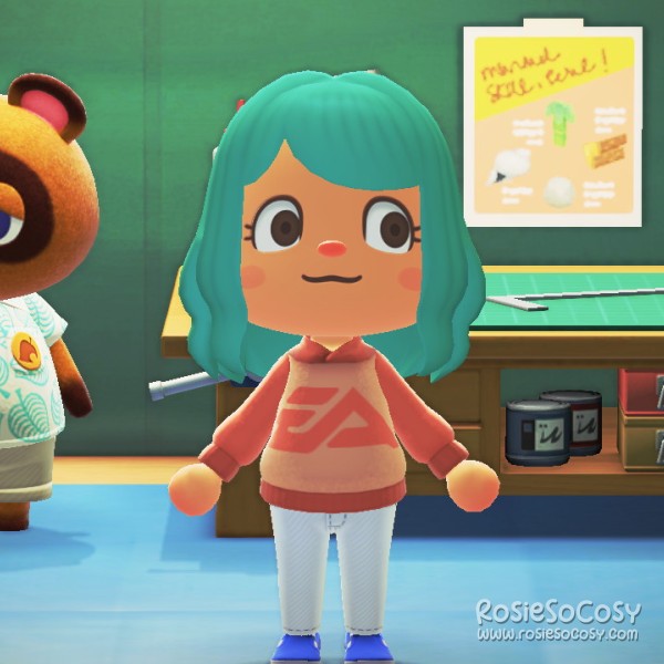 Rosie's character in Animal Crossing: New Horizons. Rosie has a medium skin tone, seafoam hair and brown eyes. She is wearing a custom design hoodie. It's a beige brown body with the EA logo in orange. The sleeves are the same colour orange. She is wearing white jeans and blue shoes. Rosie is standing in the Nook tent next to Tom Nook, who is reading a book.