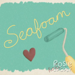 There's a yellow paint roller painting the background a seafoam colour. The seafoam is in a rectangular shape. On top of the rectangle there's the word Seafoam written together in yellow. Below on the seafoam rectangle is a red heart.