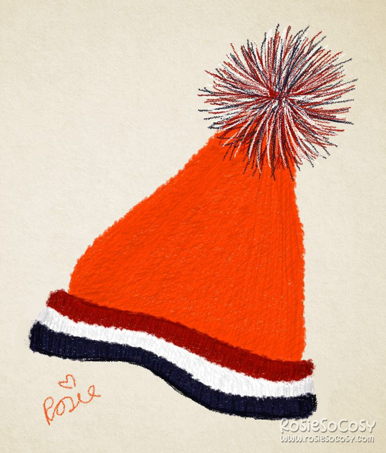 A bright orange knitted Unox winter hat, with the red, white and blue colours of the Dutch flag around it.