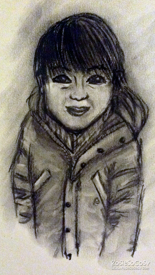 A charcoal drawing of a little boy. He has a light to medium skin colour, and darkbrown hair which reaches the top of his eyes. He is wearing a thick winter coat, with buttons and pockets on both sides. The boy has a timid smile on his face.